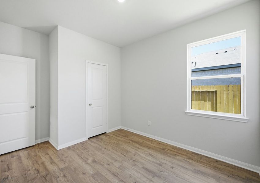 Secondary bedroom with closet and vinyl flooring in Montgomery floor plan