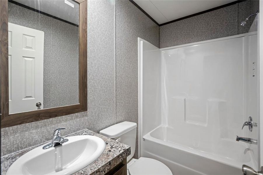Bathroom with vanity, shower / tub combination, and ornamental molding