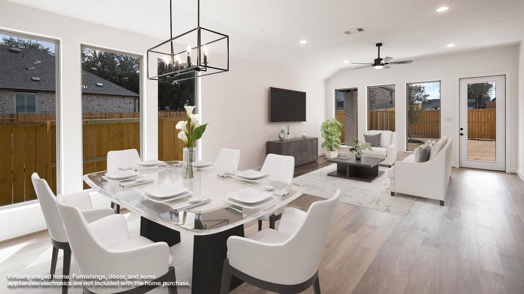 Dining area featuring recessed lighting, light wood-style flooring, ceiling fan, a chandelier, and lofted ceiling