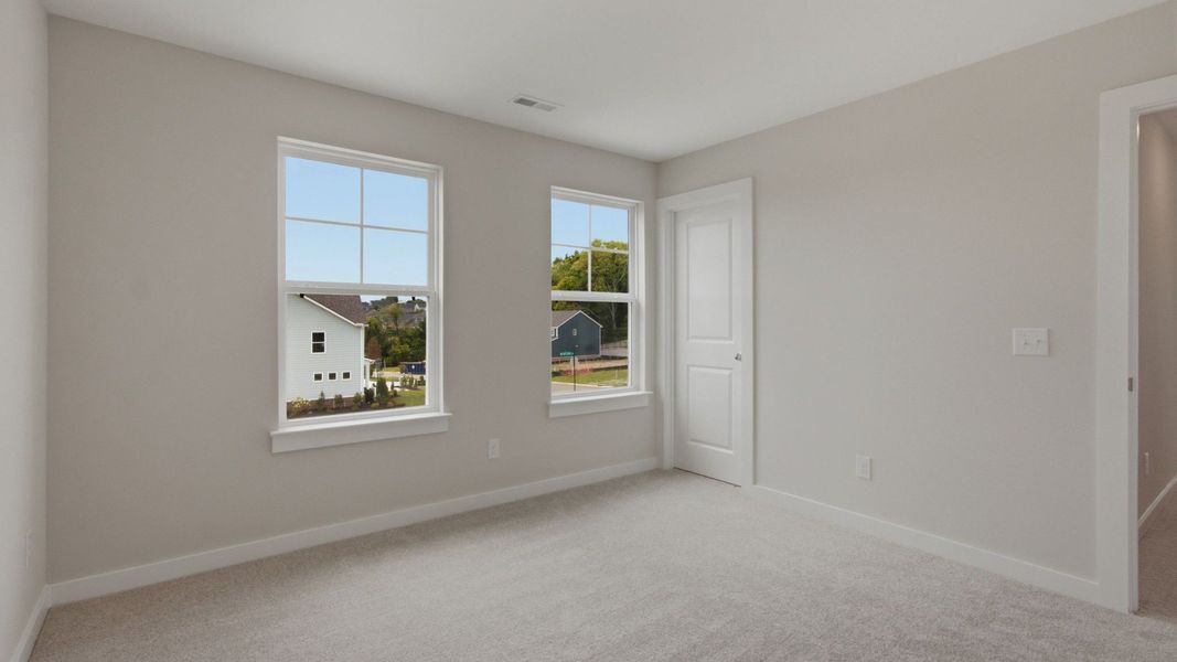 Upstairs secondary bedroom with closet