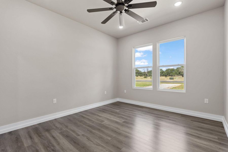 Sun-filled room boasts resilient flooring and a ceiling fan, offering comfortable living. Sun-filled room boasts resilient flooring and a ceiling fan, offering comfortable living.