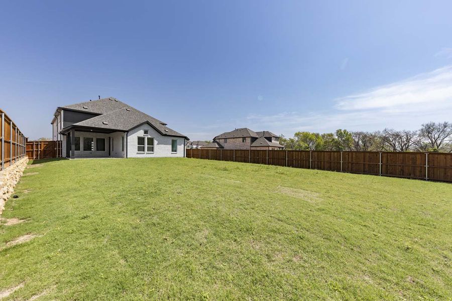 Exterior details and patio area of a home in The Reserve at Spiritas Ranch, Little Elm (Image 26).