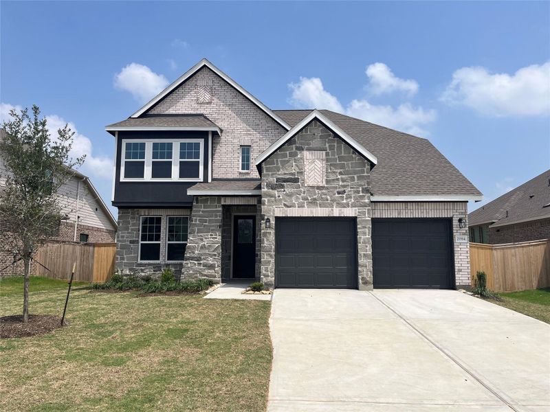 Front exterior of a new home in Oakwood Estates, Waller, TX, highlighting curb appeal (Image 26). Front exterior of a new home in Oakwood Estates, Waller, TX, highlighting curb appeal (Image 26).