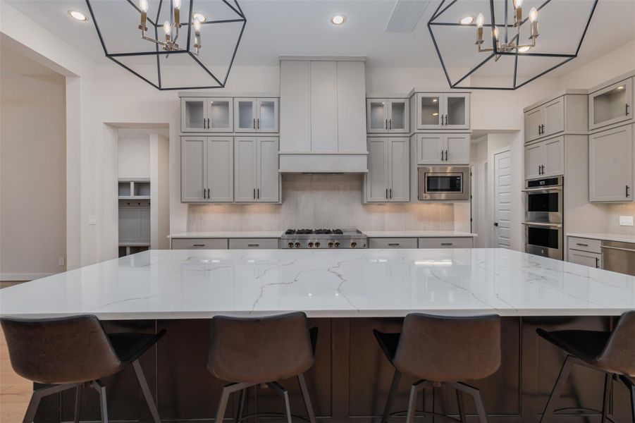 Bird's eye view of this amazing gourmet kitchen, linear and clean and perfectly functional with professional upgraded SS appliances superbly enhanced with recessed lighting and elegant chandeliers.