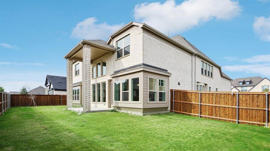 Rear view of property featuring a patio, a fenced backyard, and brick siding Rear view of property featuring a patio, a fenced backyard, and brick siding