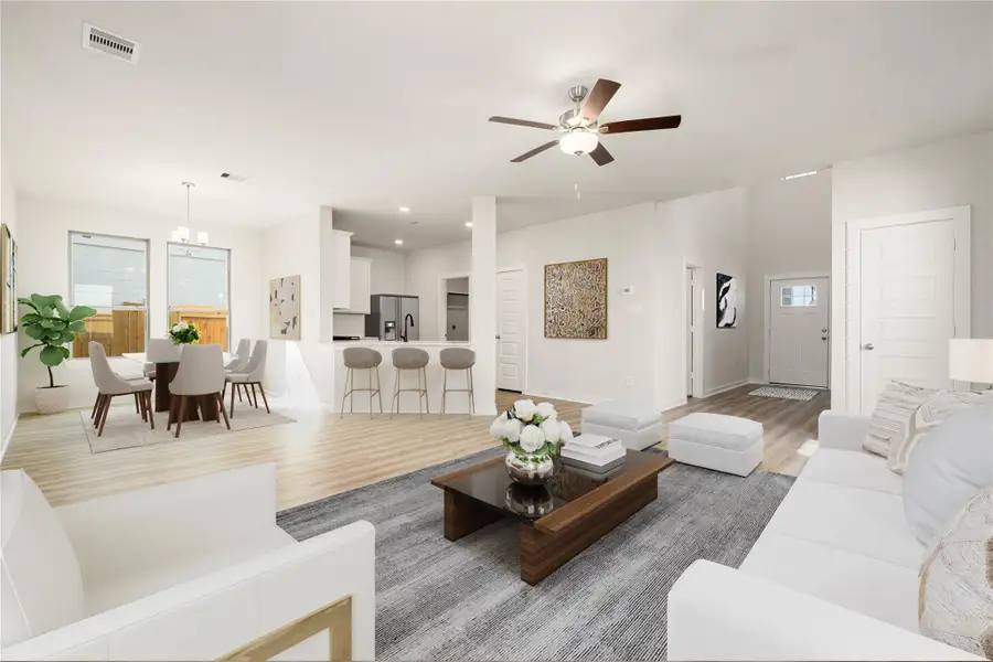 This bright and inviting open-concept living space features expansive windows that fill the room with natural light. The seamless flow between the living, dining, and kitchen areas creates an airy and functional layout. Modern finishes, recessed lighting, and warm wood-look flooring add to the home’s clean and contemporary appeal. This bright and inviting open-concept living space features expansive windows that fill the room with natural light. The seamless flow between the living, dining, and kitchen areas creates an airy and functional layout. Modern finishes, recessed lighting, and warm wood-look flooring add to the home’s clean and contemporary appeal.