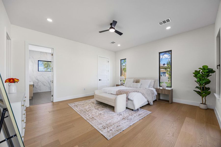 Bedroom featuring light wood-style flooring, a ceiling fan, and recessed lighting