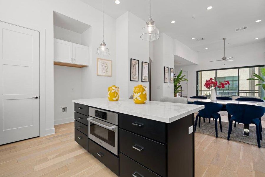An inviting open-concept kitchen features a large island, gleaming countertops, and seamless access to the dining area. An inviting open-concept kitchen features a large island, gleaming countertops, and seamless access to the dining area.