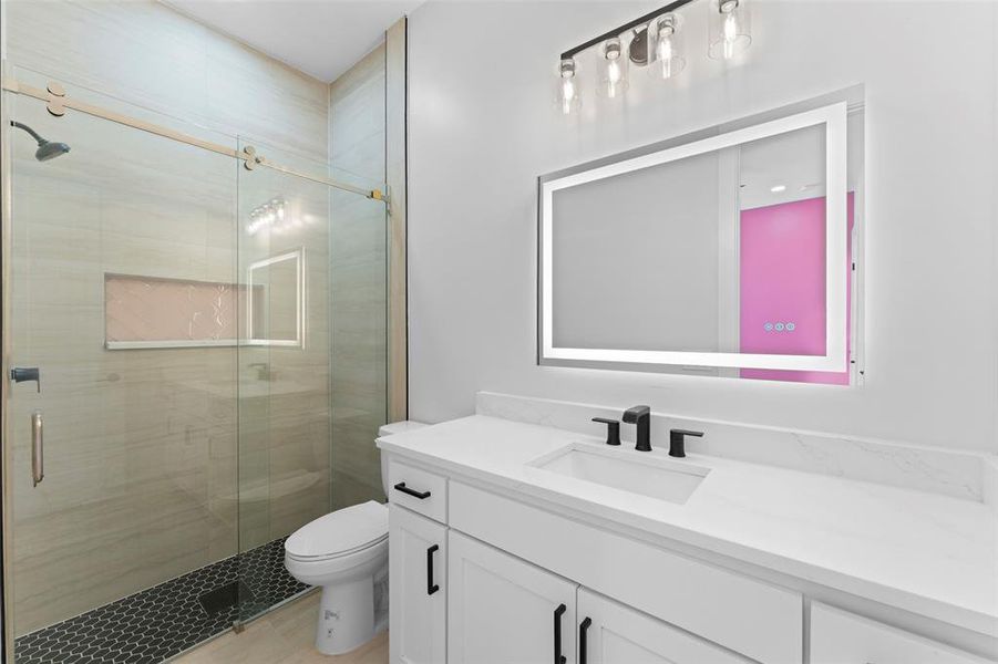 Full bath featuring vanity and a stall shower Full bath featuring vanity and a stall shower