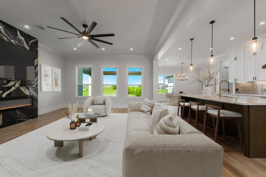 Virtual Staging - Living area with crown molding, plenty of natural light, light wood finished floors, a high end fireplace, and a chandelier Virtual Staging - Living area with crown molding, plenty of natural light, light wood finished floors, a high end fireplace, and a chandelier