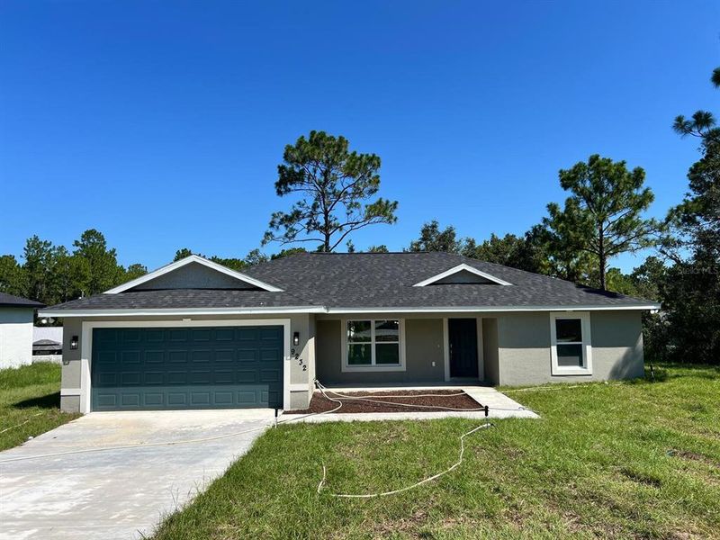Front exterior of a new home in , Citrus Springs, FL, highlighting curb appeal (Image 1).