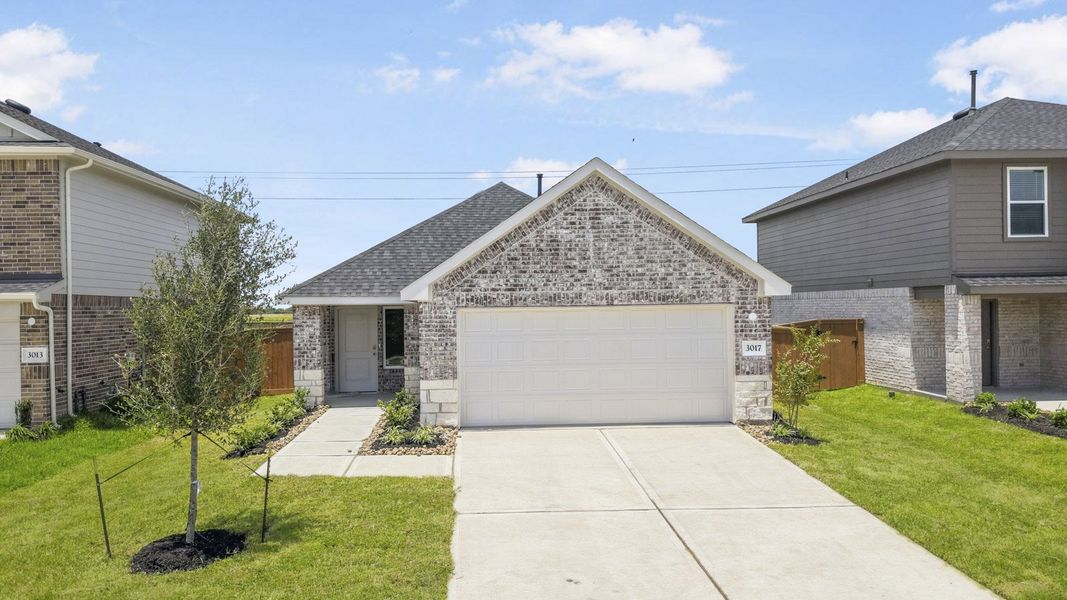Front exterior of a new home in Sunterra, Katy, TX, highlighting curb appeal (Image 18).