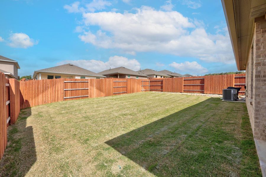 Fenced backyard with a residential view