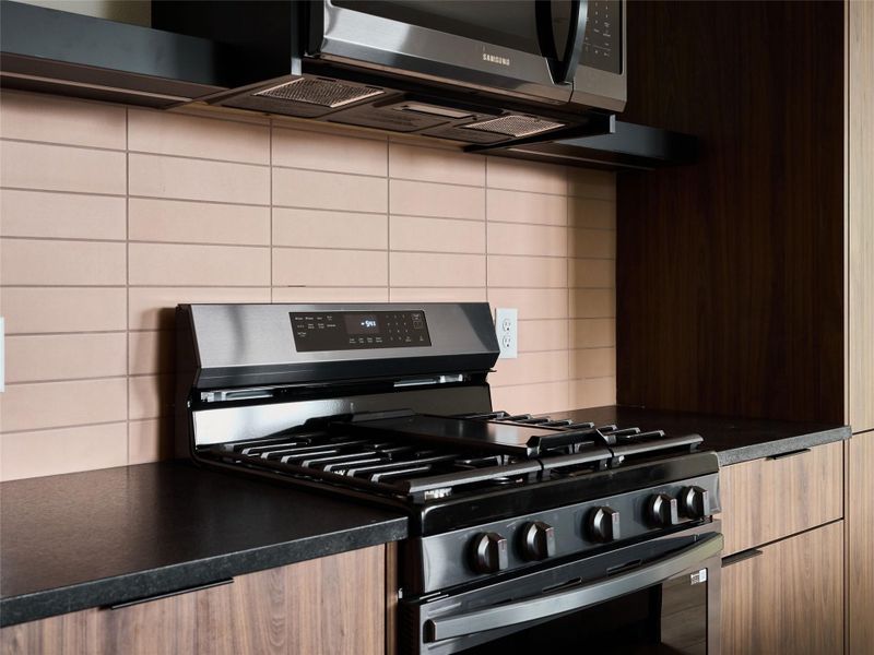 Kitchen featuring stainless steel appliances and modern cabinets Kitchen featuring stainless steel appliances and modern cabinets