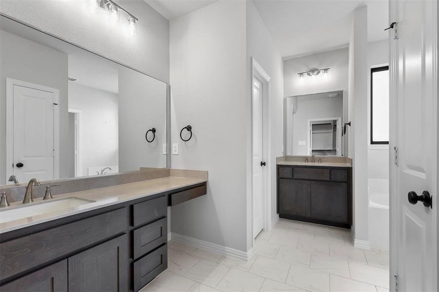 Bathroom with tile patterned floors and vanity