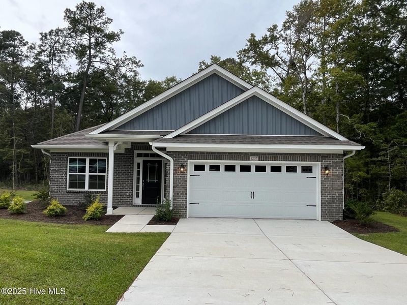 Front exterior of a new home in Palmetto Creek, Bolivia, NC, highlighting curb appeal (Image 1).