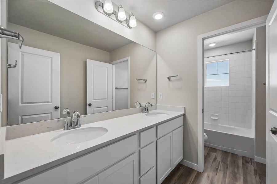 A bathroom with a sink and a shower unit.