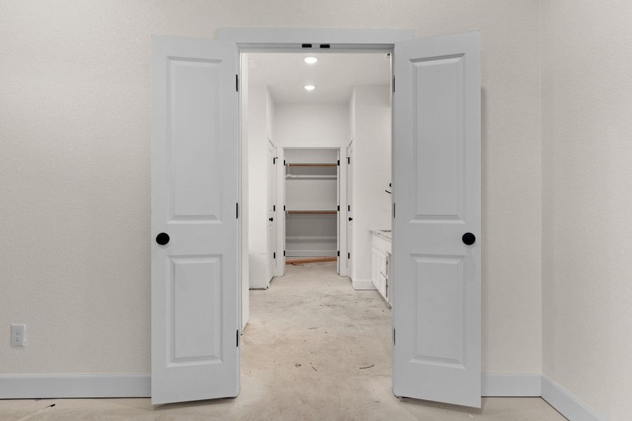 Hall featuring unfinished concrete floors and baseboards Hall featuring unfinished concrete floors and baseboards