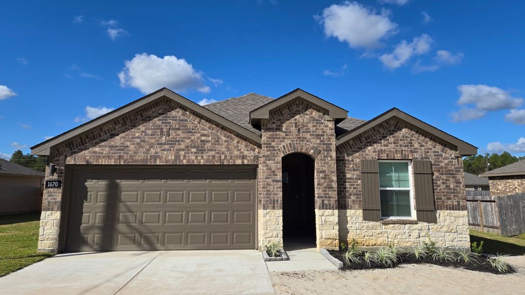 Front exterior of a new home in Holly Trails, Sour Lake, TX, highlighting curb appeal (Image 1).