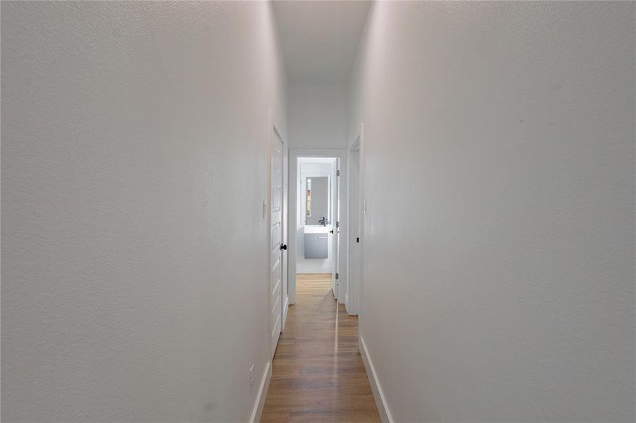 Hallway leading to In-Law Suite with dark wood-type flooring and baseboards Hallway leading to In-Law Suite with dark wood-type flooring and baseboards