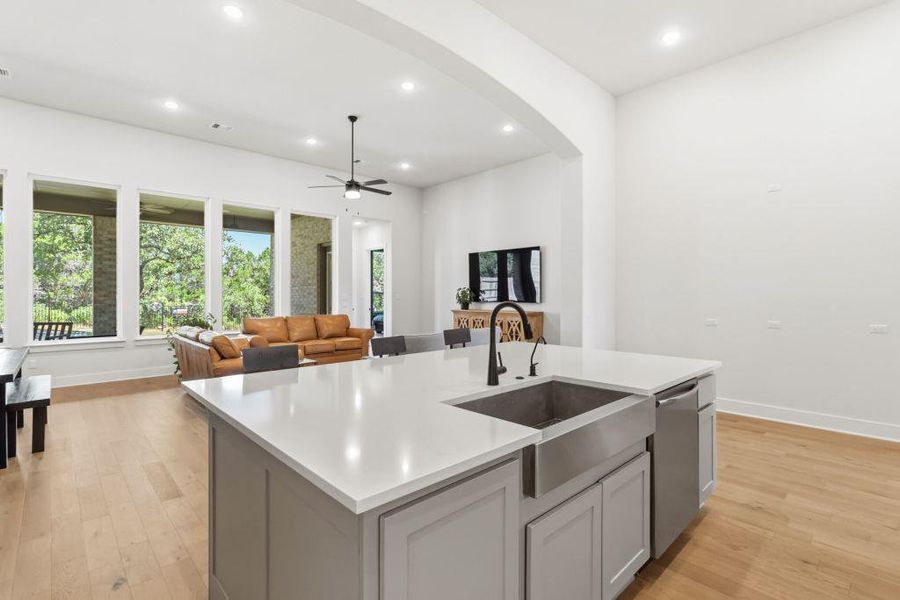 A spacious, open-concept living area with abundant natural light features a large kitchen island.