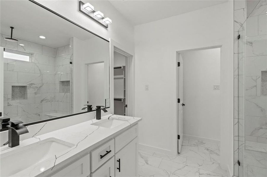 Bathroom with vanity and a tile shower