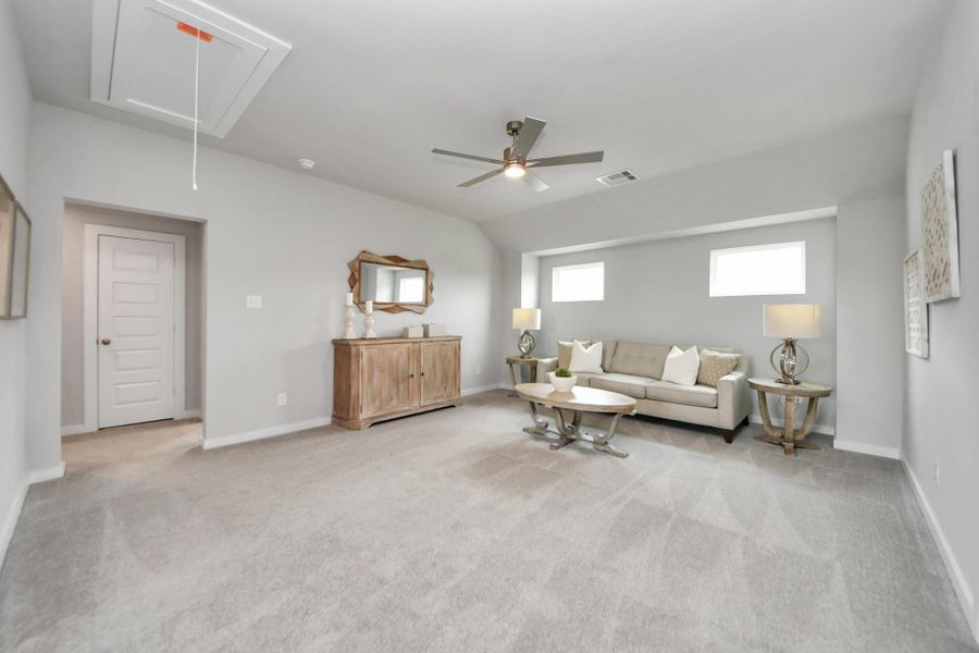 Come upstairs and relish a day of relaxation in this loft area! Ideal as an additional living space or game room, it boasts plush carpeting, high ceilings, custom paint, and windows that flood the area with abundant natural light. Come upstairs and relish a day of relaxation in this loft area! Ideal as an additional living space or game room, it boasts plush carpeting, high ceilings, custom paint, and windows that flood the area with abundant natural light.