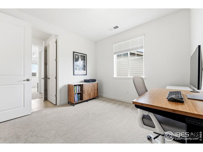 Alternate office view (bedroom 5) showing natural light and bathroom access.