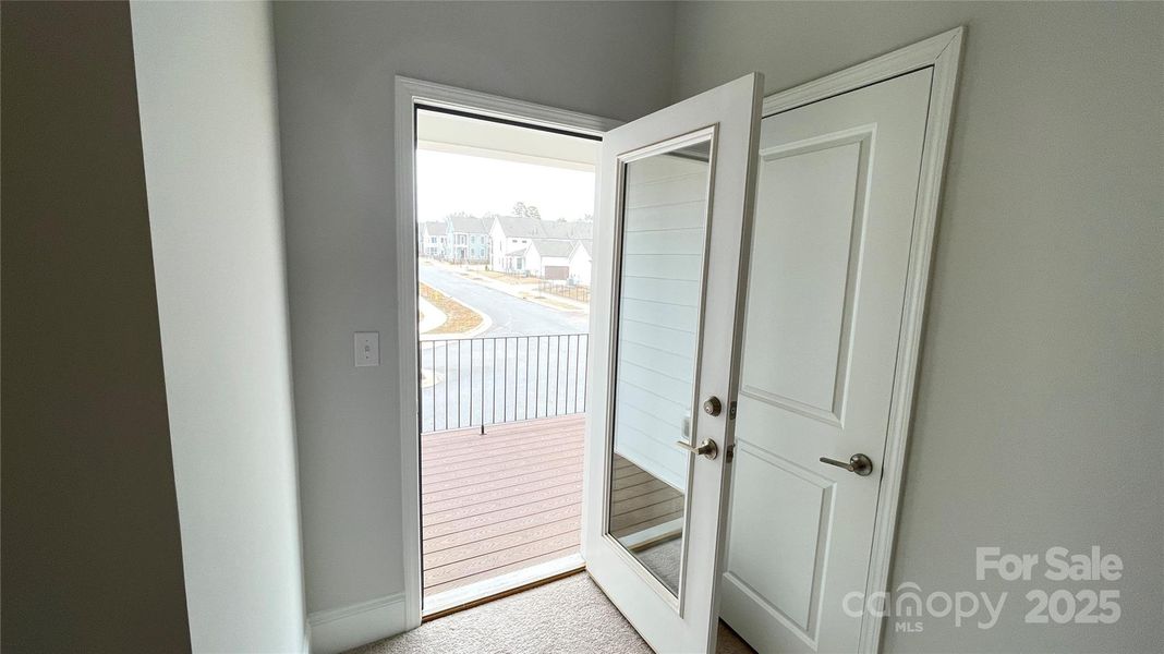 Bedroom #3 with door to upper level covered balcony - Example-Merlot Floorplan