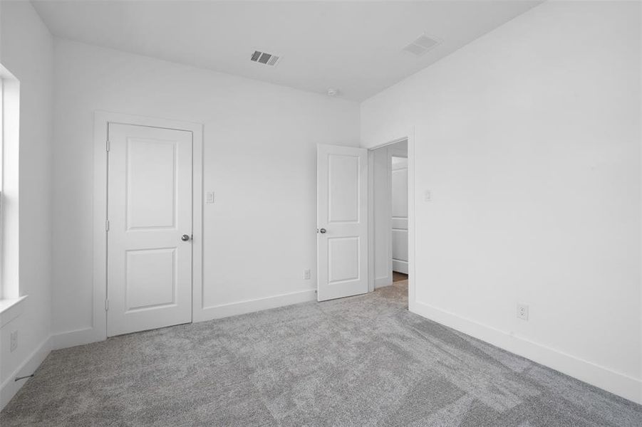 Unfurnished bedroom featuring light carpet