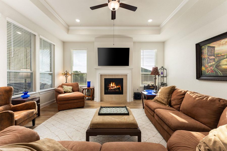 This view of the living room shows off the tray ceiling and fireplace. This view of the living room shows off the tray ceiling and fireplace.
