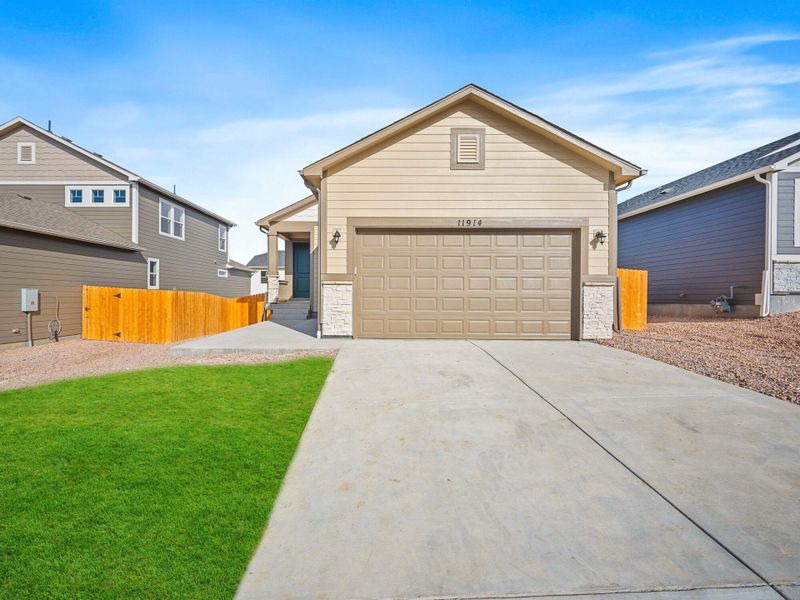Front exterior of a new home in Ridge at Lorson Ranch, Colorado Springs, CO, highlighting curb appeal (Image 2).