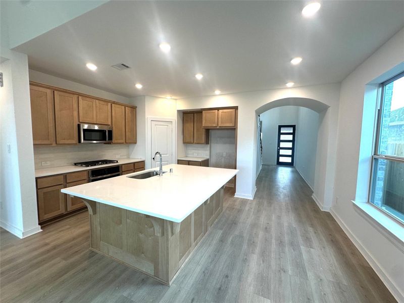 Kitchen features large wrapped island (no sheetrock island here) facing additional seating at your window seat which is standard at Highland Homes.