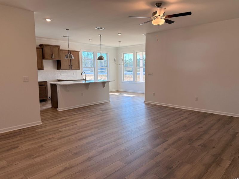 Spacious living room opening up to a gorgeous kitchen.