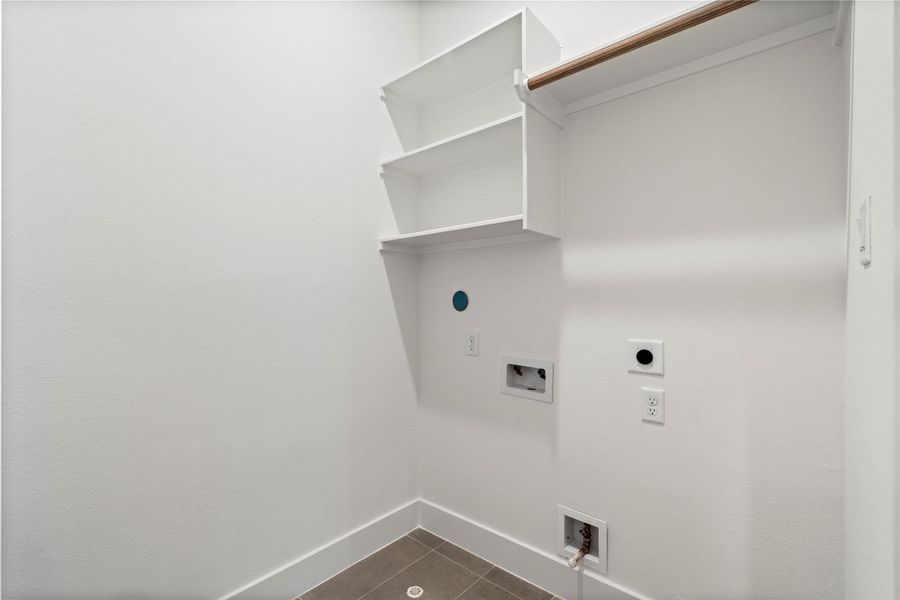 The upstairs utility room offers convenient laundry space with durable tile floors and ample storage, designed to keep everyday tasks organized and effortless. The upstairs utility room offers convenient laundry space with durable tile floors and ample storage, designed to keep everyday tasks organized and effortless.