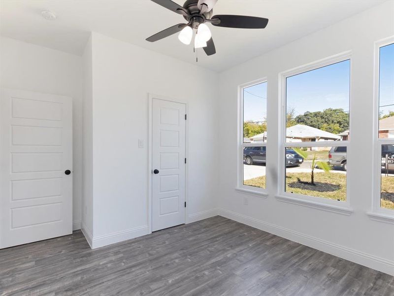 Empty room with dark hardwood / wood-style floors and ceiling fan