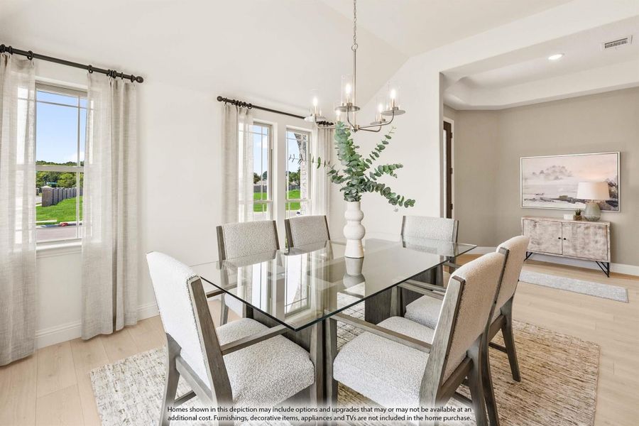 Dining room with glass-top table, six upholstered chairs, chandelier, and large windows with natural light