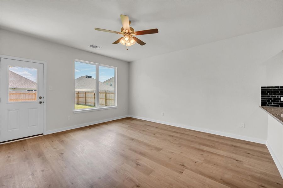 Unfurnished living room with light wood finished floors and a ceiling fan Unfurnished living room with light wood finished floors and a ceiling fan