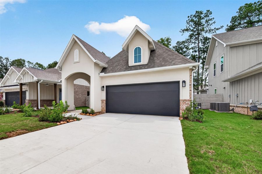Front exterior of a new home in Two Step Farm, Montgomery, TX, highlighting curb appeal (Image 2). Front exterior of a new home in Two Step Farm, Montgomery, TX, highlighting curb appeal (Image 2).