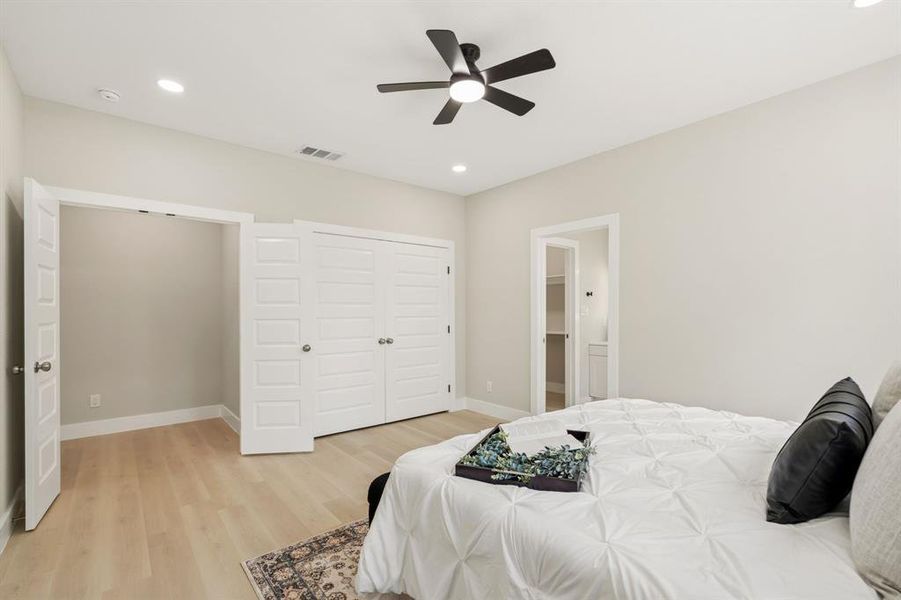 Spacious room featuring light wood-finish flooring, recessed lighting, and a ceiling fan with matte black accents Spacious room featuring light wood-finish flooring, recessed lighting, and a ceiling fan with matte black accents