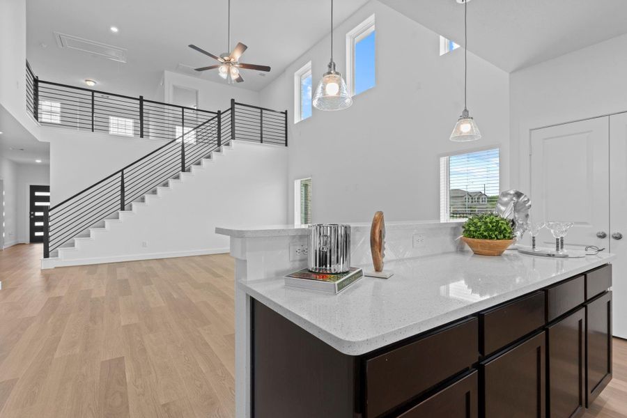 A panoramic view of the kitchen showcases the thoughtful layout, ample dark cabinetry, and easy access to the backyard through the nearby exterior door—ideal for indoor-outdoor entertaining. **Image Representative of Plan Only and May Vary as Built**. A panoramic view of the kitchen showcases the thoughtful layout, ample dark cabinetry, and easy access to the backyard through the nearby exterior door—ideal for indoor-outdoor entertaining. **Image Representative of Plan Only and May Vary as Built**.