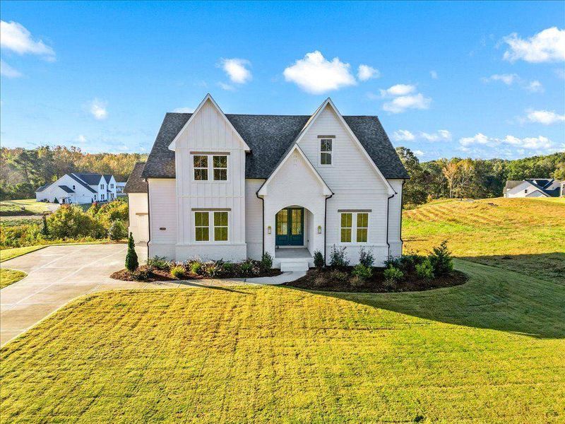 Front exterior of a new home in Brooks Pond, Cumming, GA, highlighting curb appeal (Image 1).
