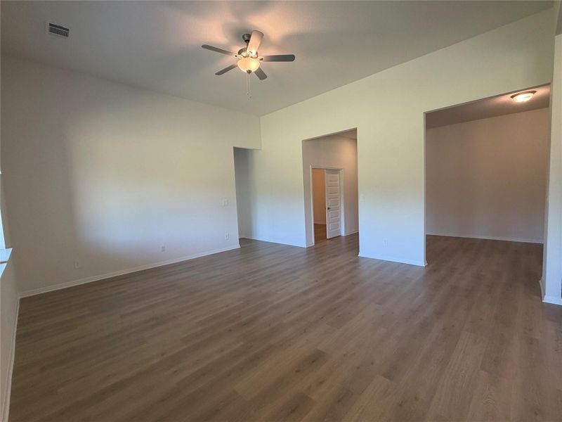 Unfurnished bedroom with dark wood-style flooring and ceiling fan
