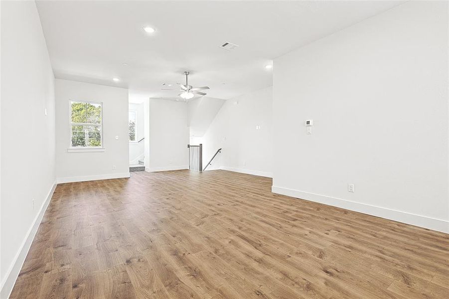 Unfurnished living room featuring light hardwood / wood-style floors and ceiling fan