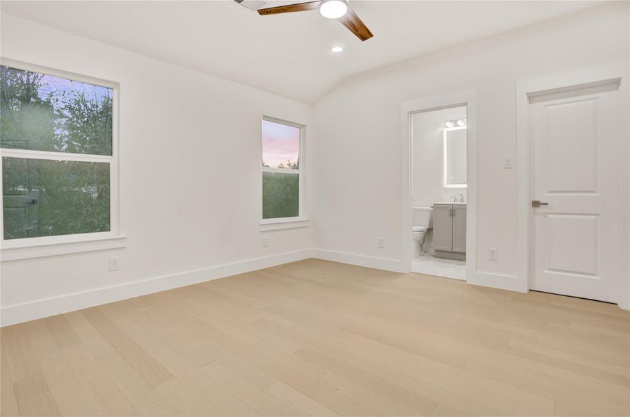 Spacious secondary bedroom with large windows and a private ensuite bath.