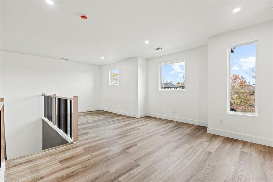 Unfurnished room with light wood-style flooring and recessed lighting
