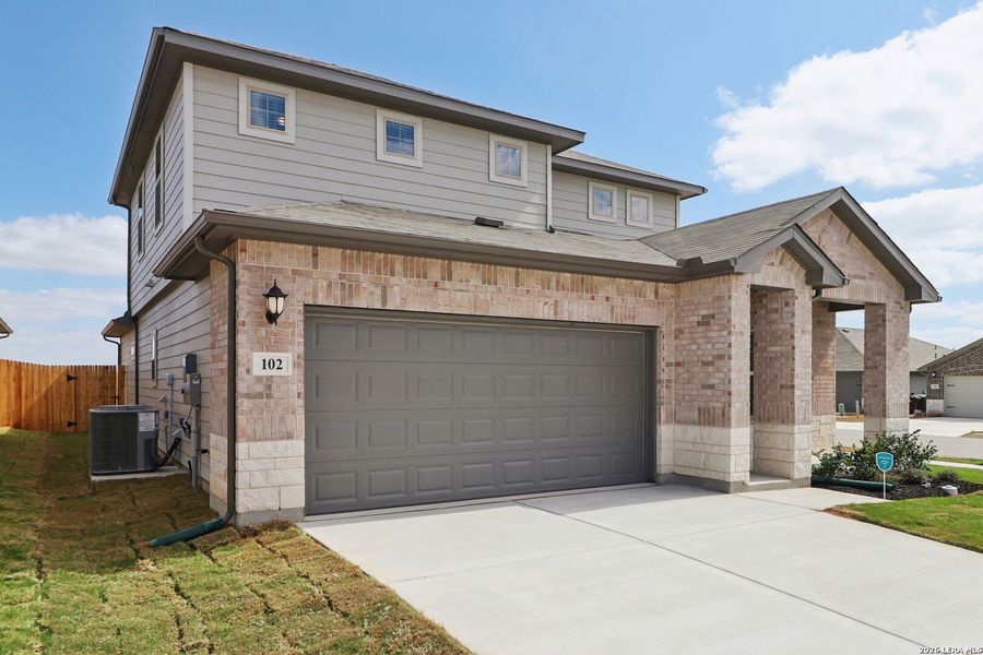 Front exterior of a new home in Legendary Trails - Premier Series, Cibolo, TX, highlighting curb appeal (Image 23).