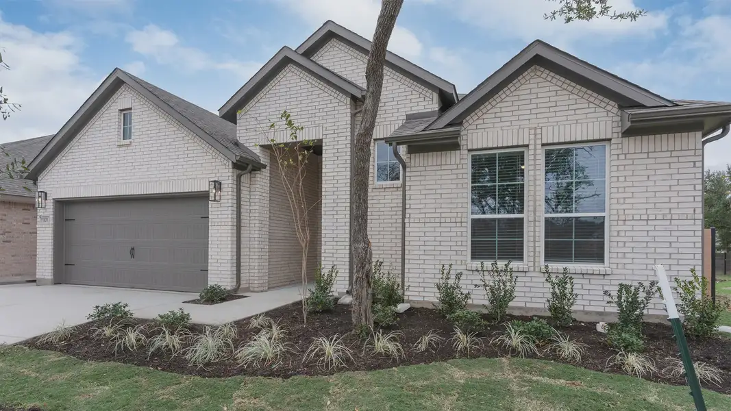 Front exterior of a new home in Newhaven, Manor, TX, highlighting curb appeal (Image 2). Front exterior of a new home in Newhaven, Manor, TX, highlighting curb appeal (Image 2).