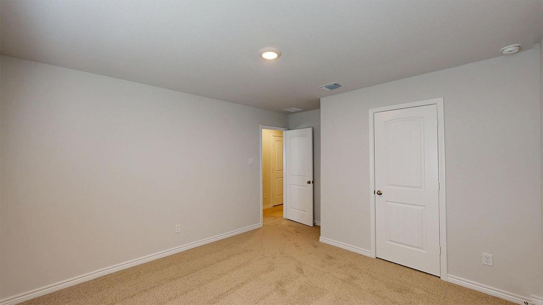 This room features neutral-toned carpet and light-colored walls, providing a versatile backdrop