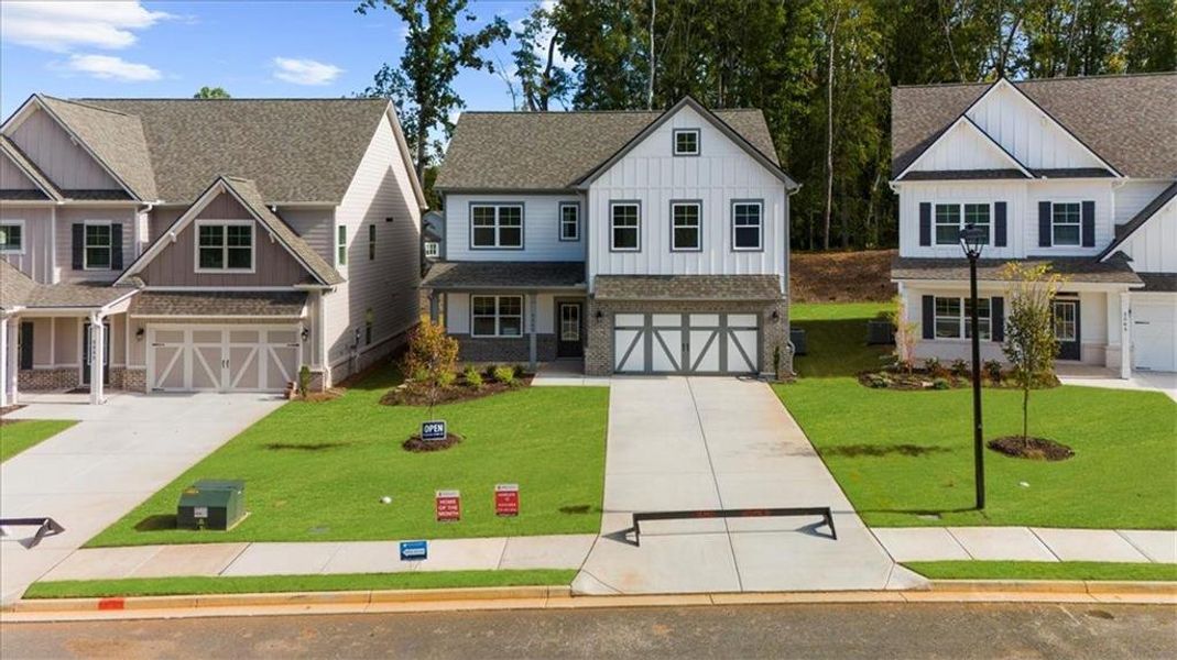 Front exterior of a new home in , Flowery Branch, GA, highlighting curb appeal (Image 2).